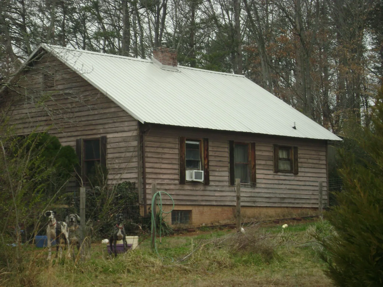 White metal roof on an old wood sided farmhouse, from a Metal Roof Installation job in Plain